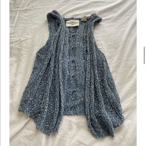 Sweater vest, not a heavy material, cute over other tank tops or over a dress